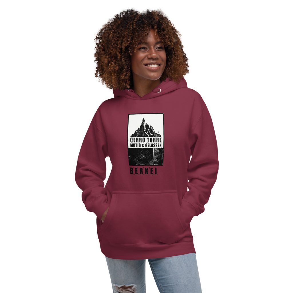 Junge Frau trägt BERKEI Cerro Torre Mutig & Gelassen Hoodie in Maroon, ideal für Abenteuer.