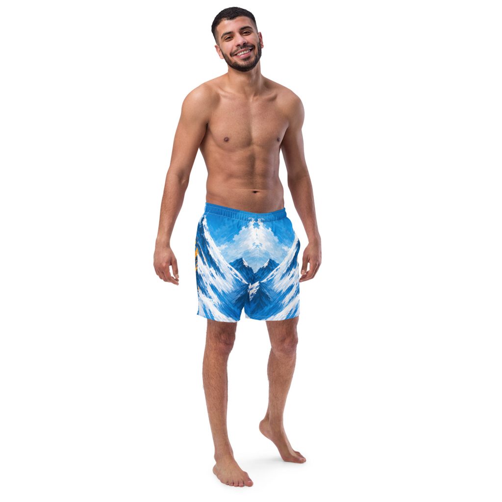 Mann in BERKEI Badehose Alpine Rush mit Bergmotiv in Blau